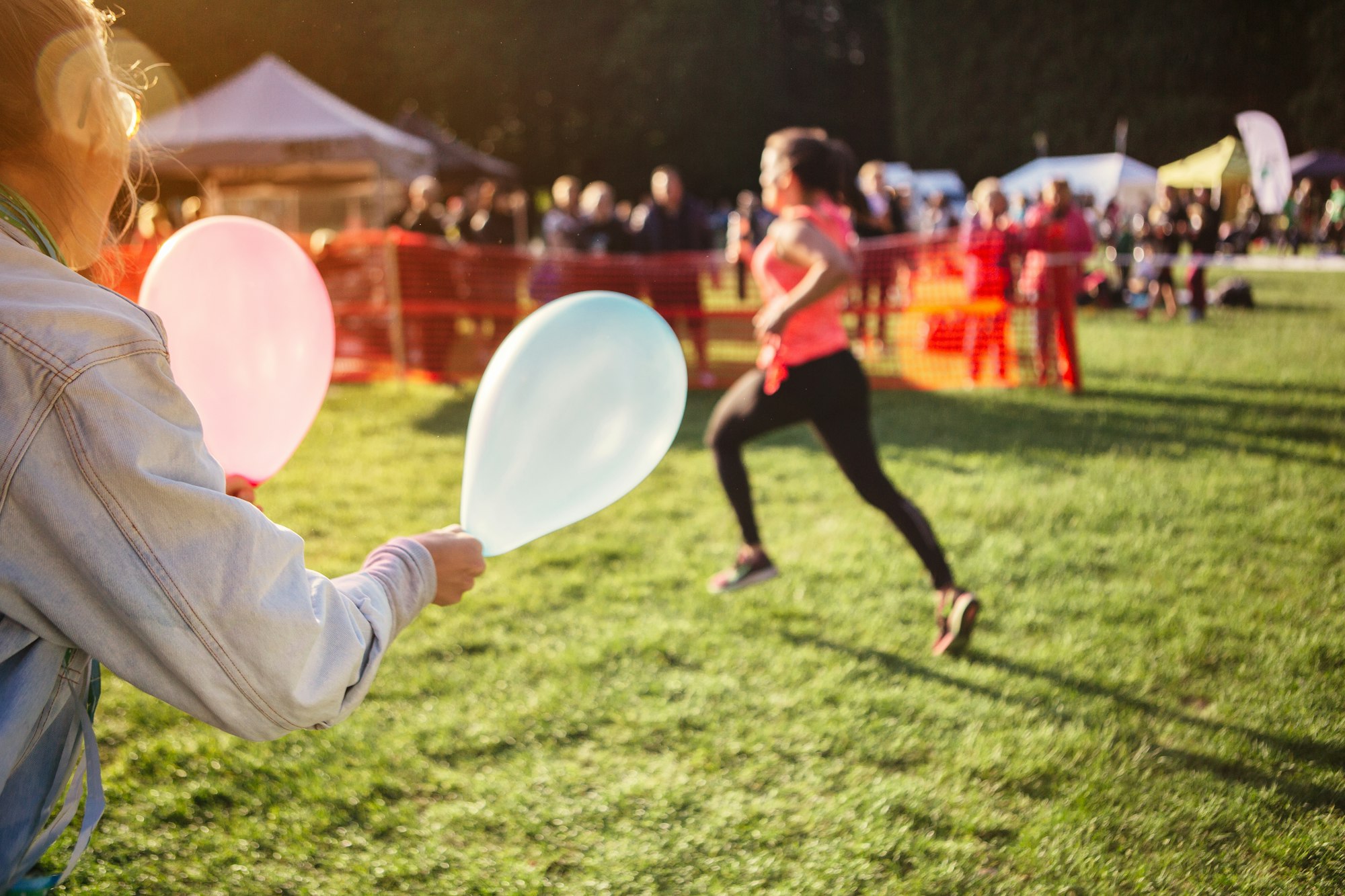 Supporter holding balloons at sports event